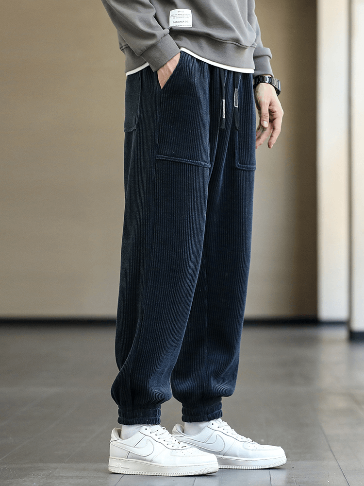 Men's loose corduroy joggers with elastic hem and pockets, stylish and comfortable fit for casual wear.